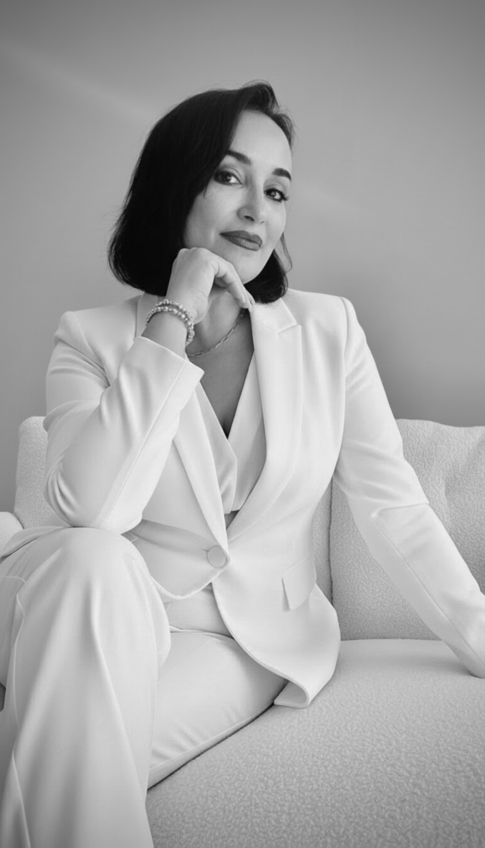 Professional portrait of Dr. Neeta in elegant white suit